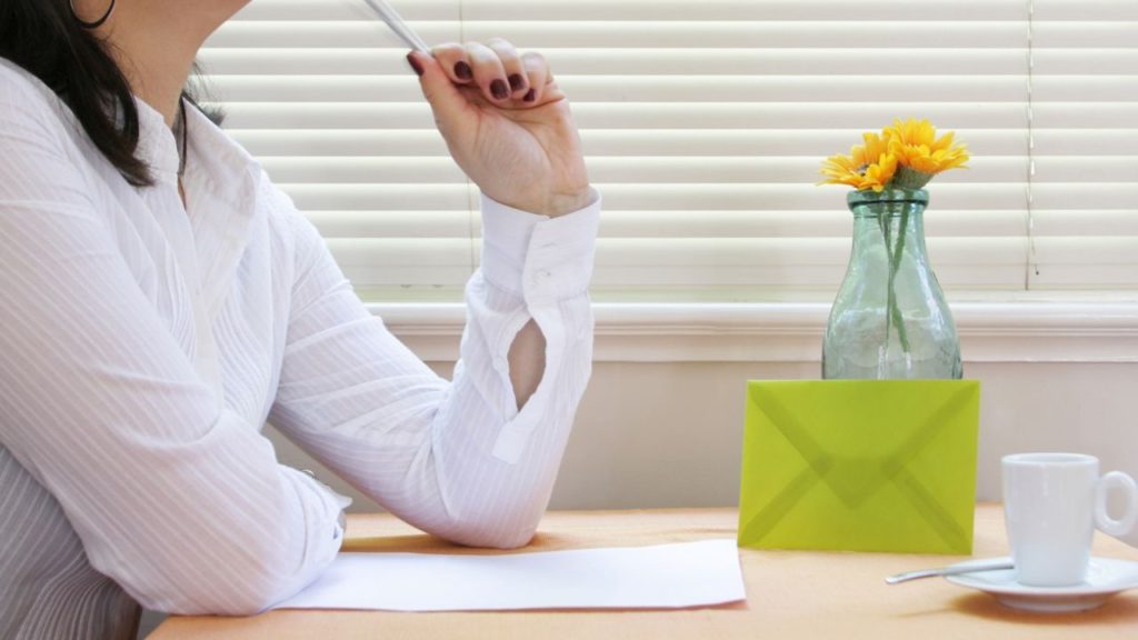 A person thinking her initial phrase for a telephone pictionary game