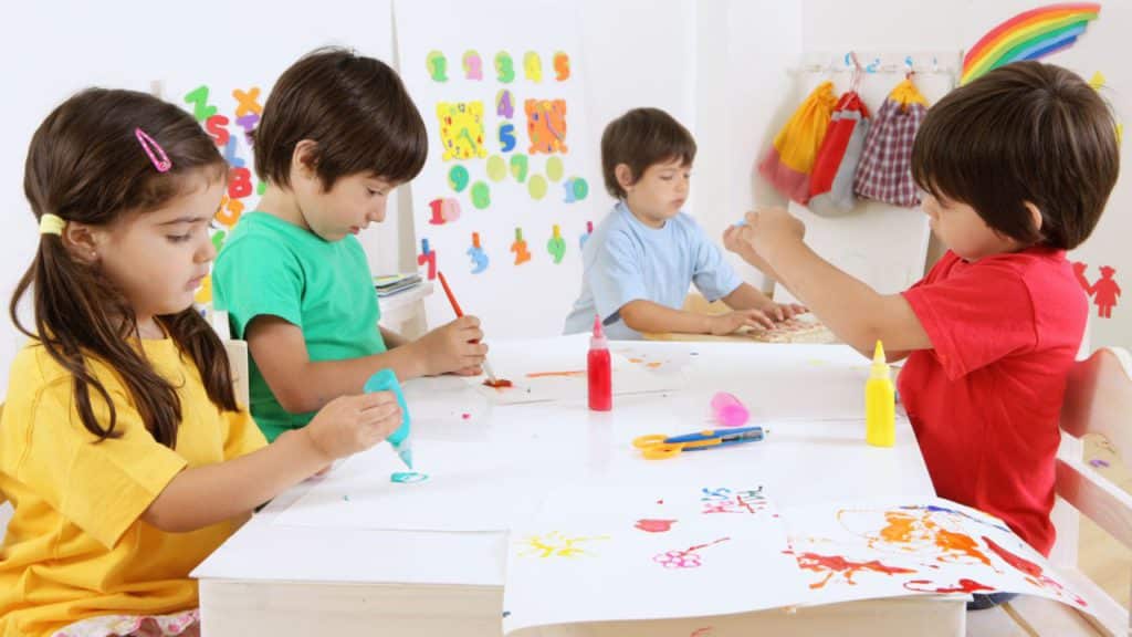 Kids making DIY fall activities.