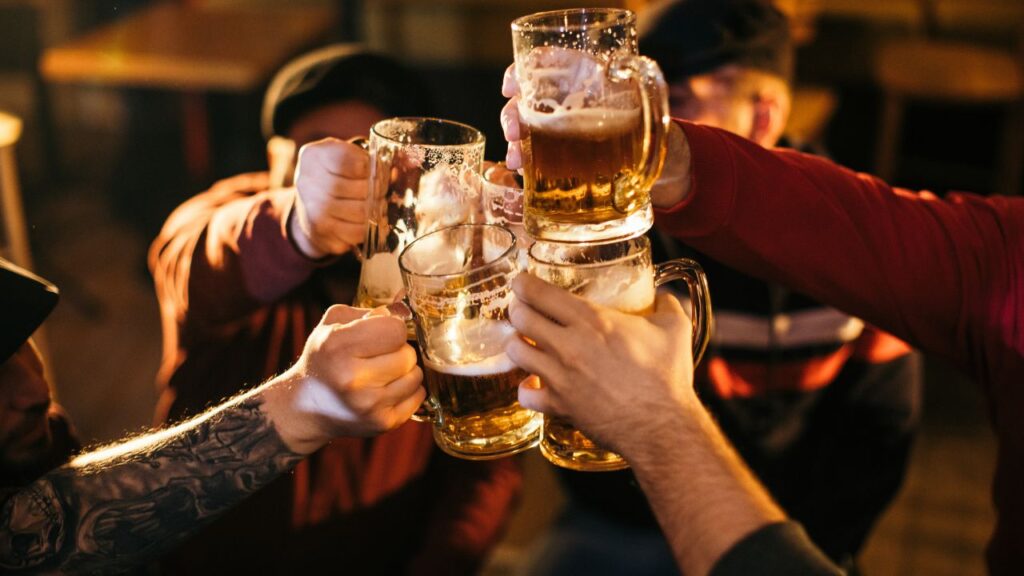 Photo of men holding a glass of beer