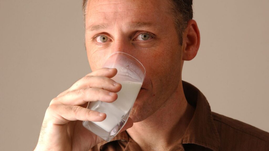 Man drinking a glass of milk