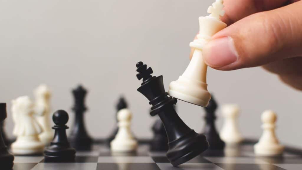 Photo of a person holding a chess piece