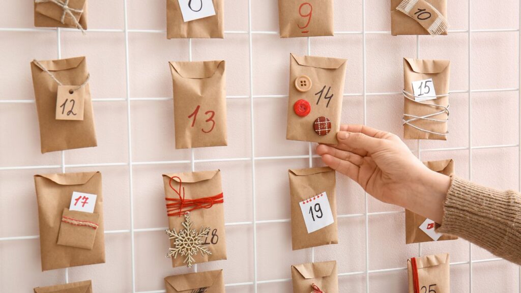 A woman hanging an advent calendar