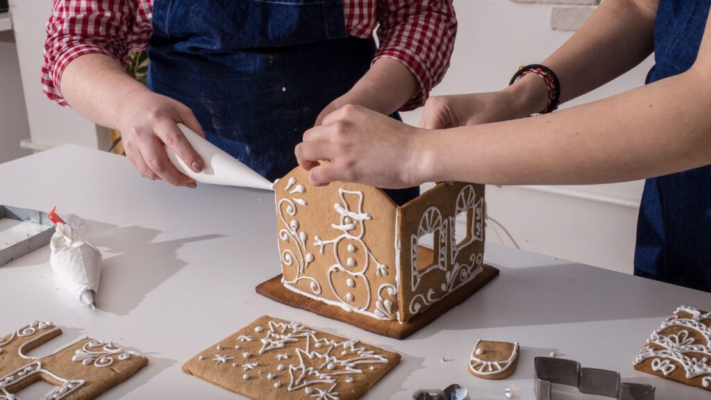 A family building a gingerbread house