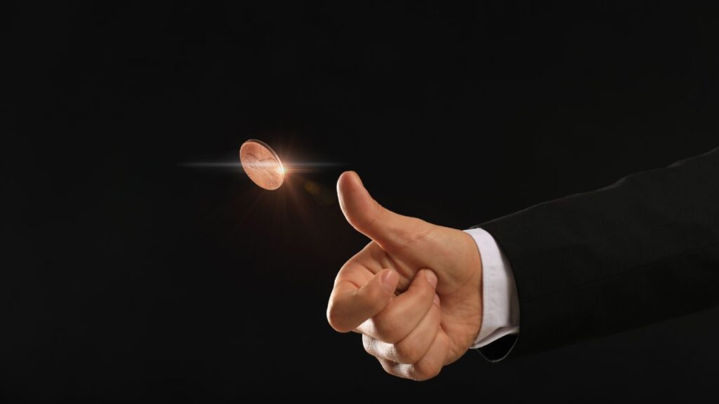 A person tossing a coin